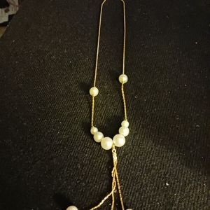 Gold tone necklace with pearl slide beads and gold tossels with pearls
